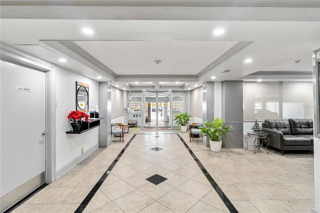 33 South Gulfstream Avenue, Unit 502 Sarasota, FL 34236 - Photo 22 of 23 a lobby with furniture and potted plants