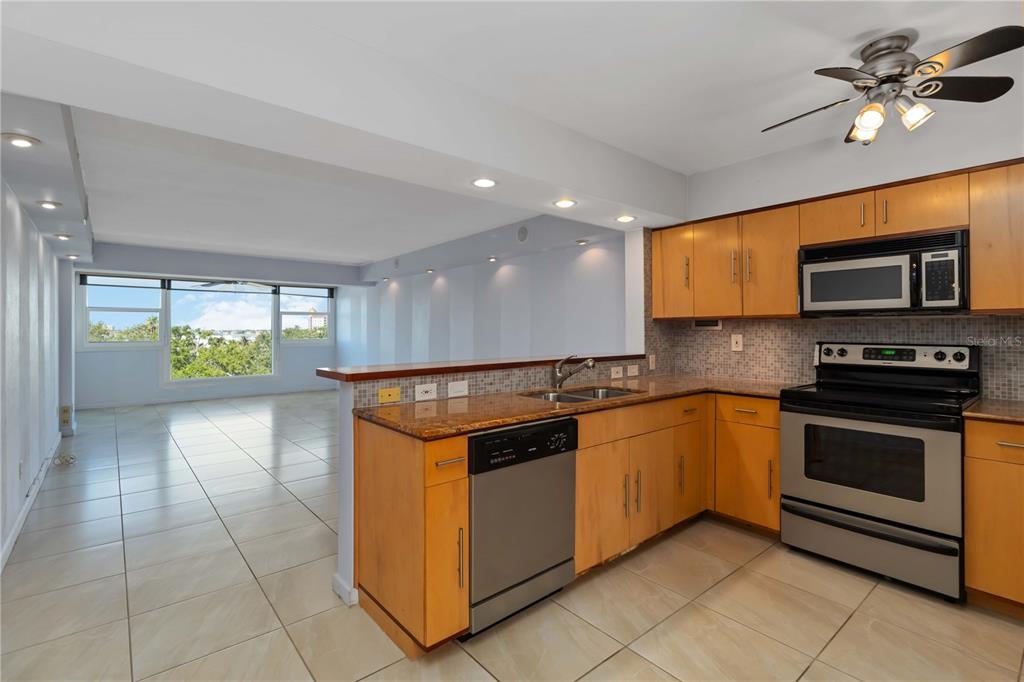 33 South Gulfstream Avenue, Unit 502 Sarasota, FL 34236 - Photo 4 of 23 a kitchen with stainless steel appliances granite countertop a stove a sink and a refrigerator