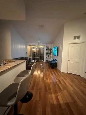 a living room with furniture a flat screen tv and a window