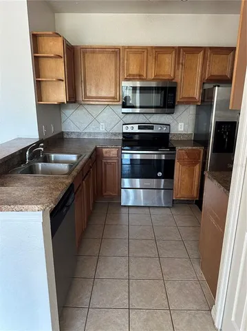 a kitchen with a stove a sink and a microwave