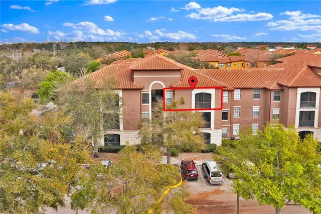an aerial view of a house with a swimming pool patio and outdoor seating