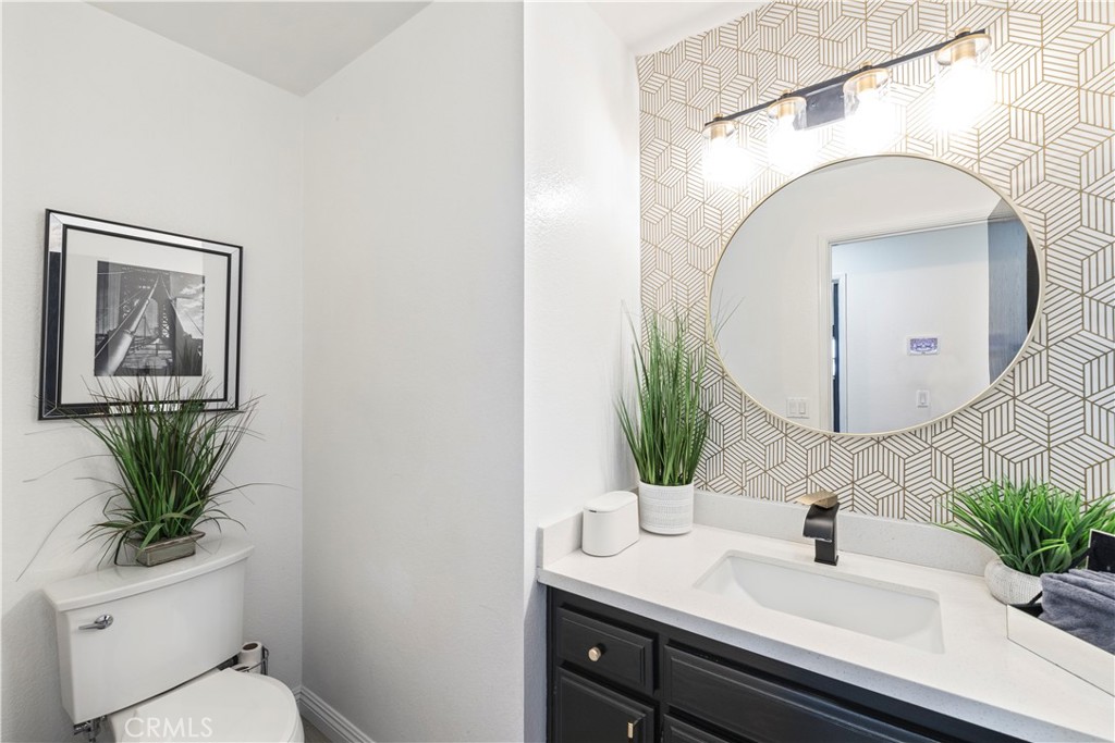 14272 Laurel Drive Riverside, CA 92503 - Photo 11 of 24 a bathroom with a toilet a sink and mirror