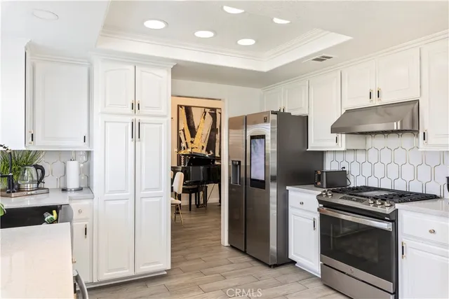 a kitchen with stainless steel appliances a refrigerator sink and stove