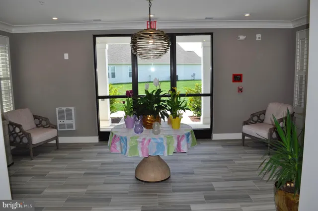 a living room with furniture fireplace and large windows