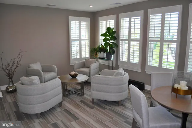 a view of a patio with lawn chairs next to a yard