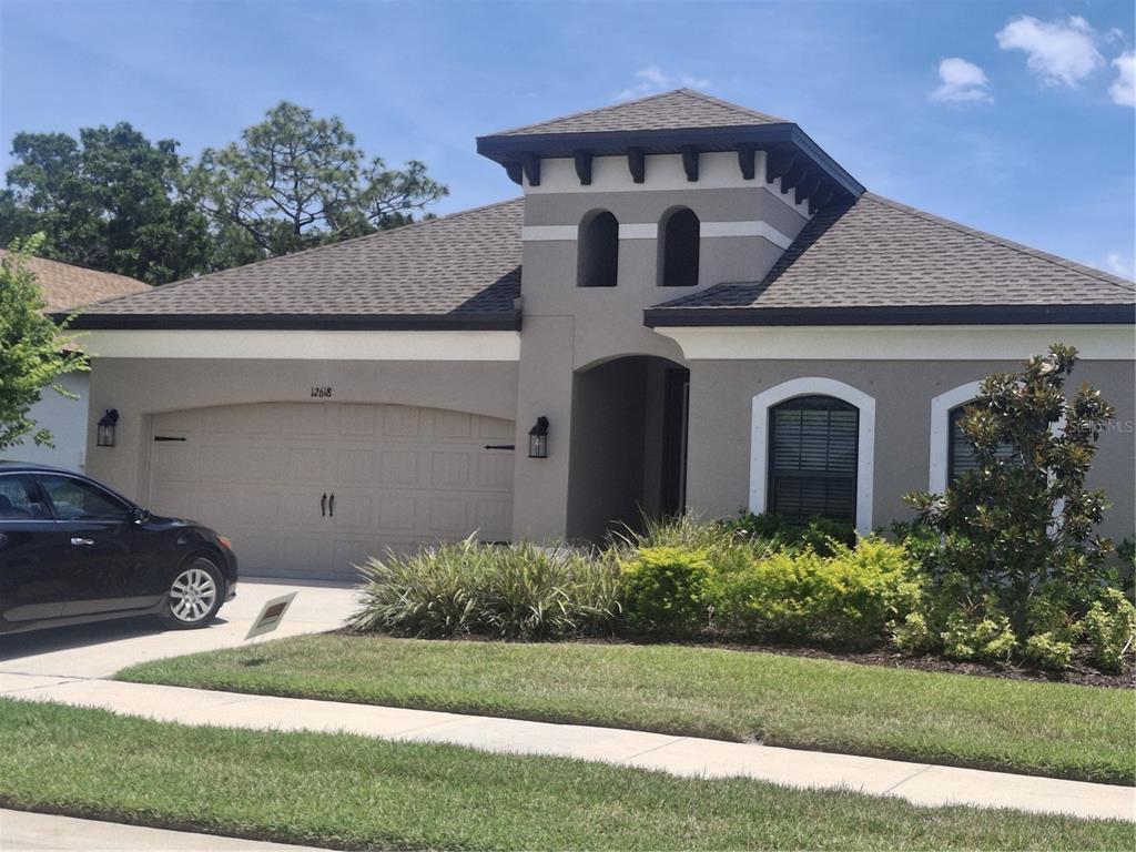 12618 Vander Way New Port Richey, FL 34654 - Photo 1 of 22 a front view of a house with a yard
