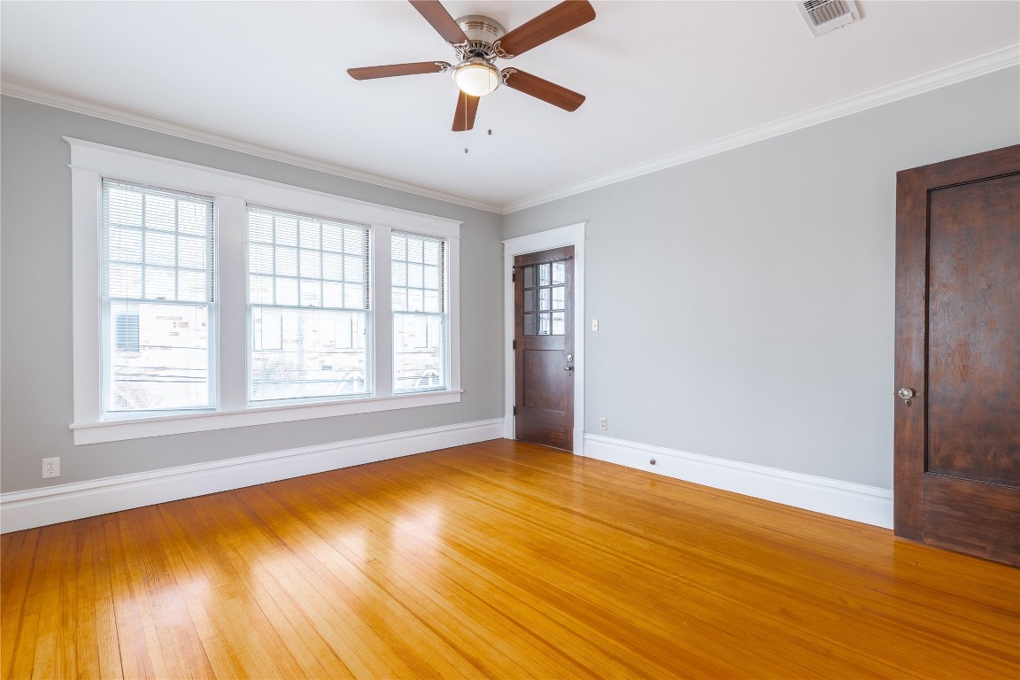 806 Winbern Street, Unit 2 Houston, TX 77002 - Photo 3 of 11 a view of an empty room with wooden floor and a window