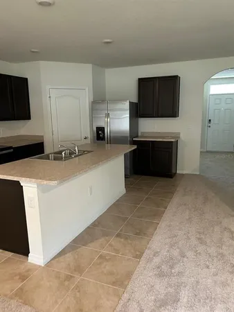 a large kitchen with a stove and a microwave