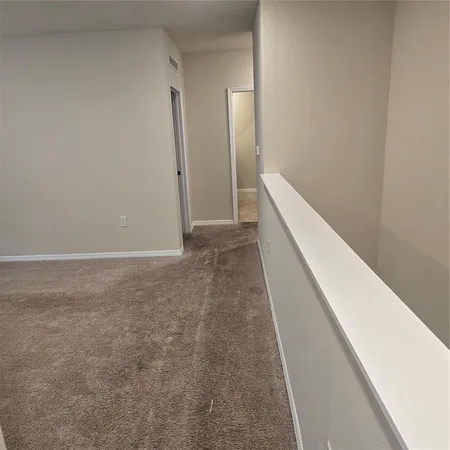 a kitchen with stainless steel appliances granite countertop a sink a stove a refrigerator and a refrigerator