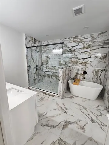 a view of room with washer and flat screen tv