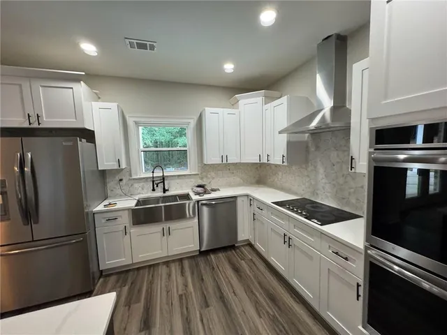 a kitchen with a white stove top oven and refrigerator