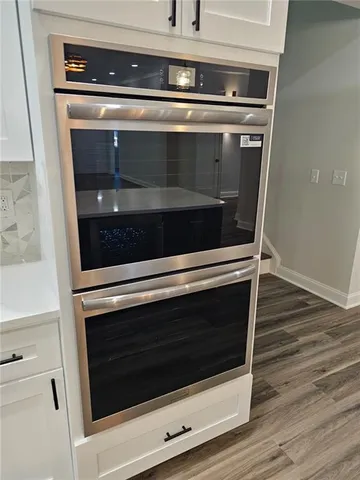 a stove top oven sitting inside of a kitchen