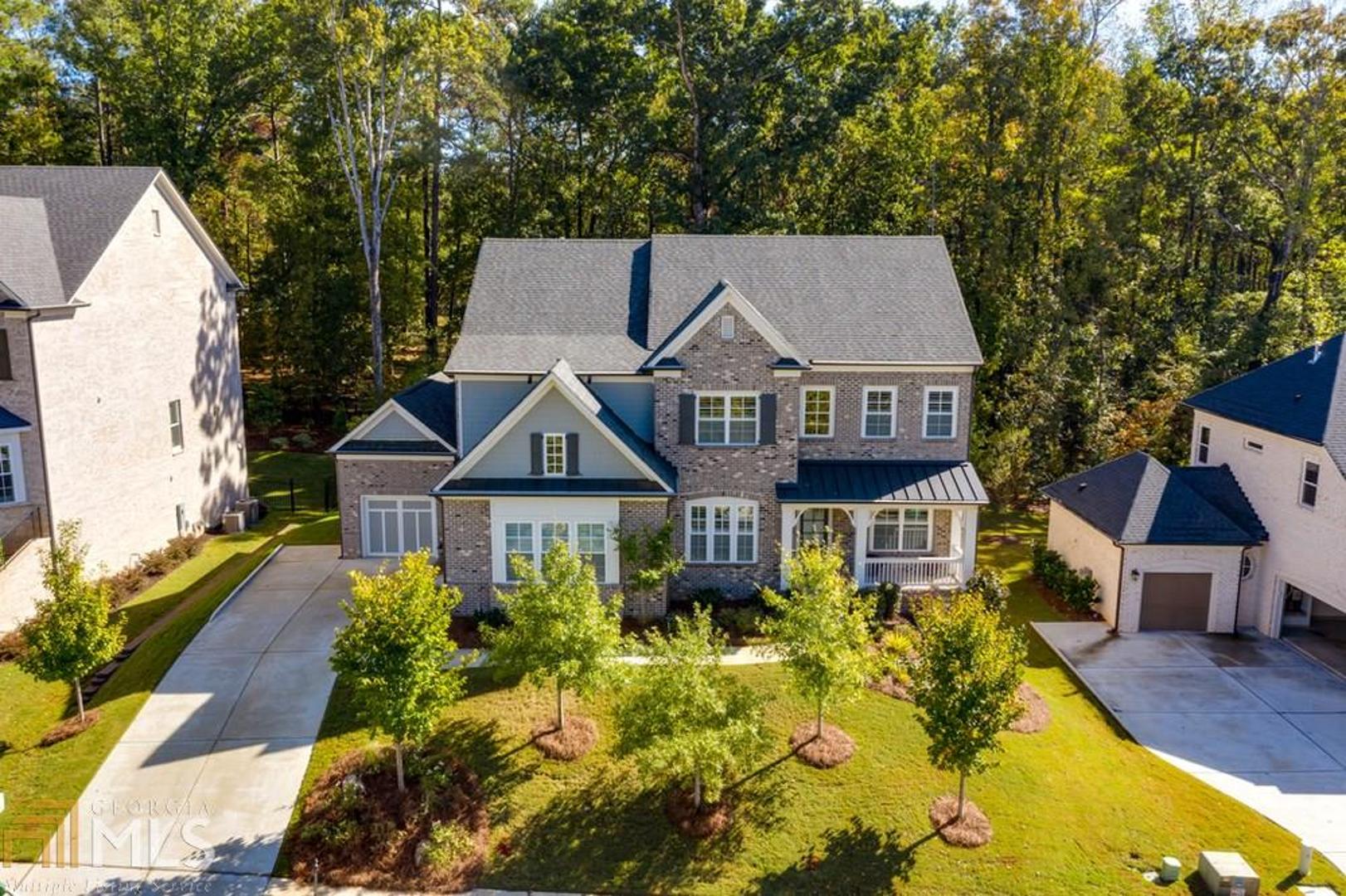 4 sided BRICK beauty in Johns Creek with inviting front porch!