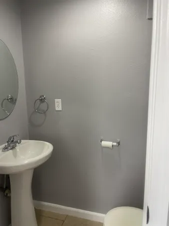 a bathroom with a sink mirror and toilet
