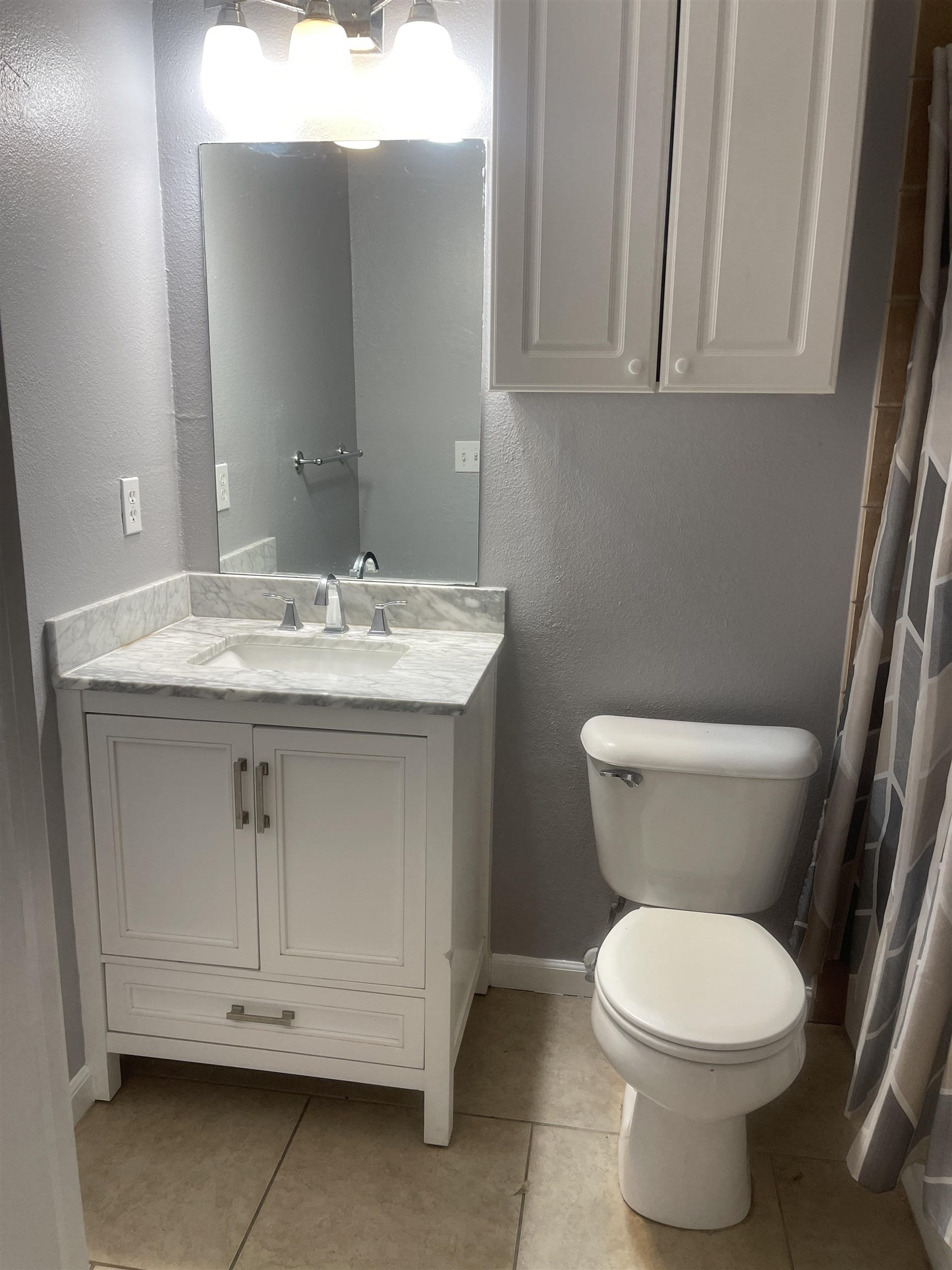 4420 Carter Road, Unit 22 St. Augustine, FL 32086 - Photo 8 of 12 a bathroom with a toilet sink and mirror