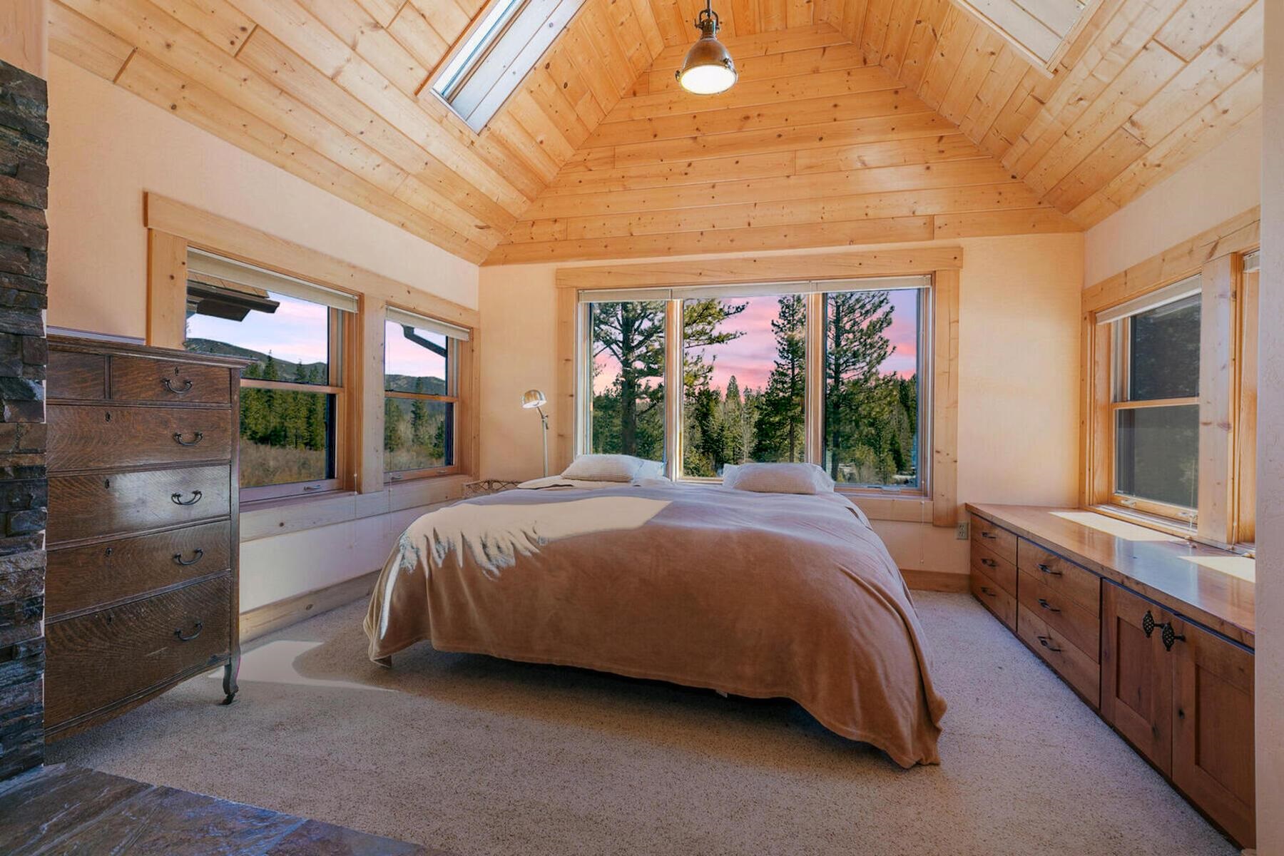 1711 Smith Lake Road Graeagle, CA 96103 - Photo 11 of 26 a spacious bedroom with a bed and a painting on the wall