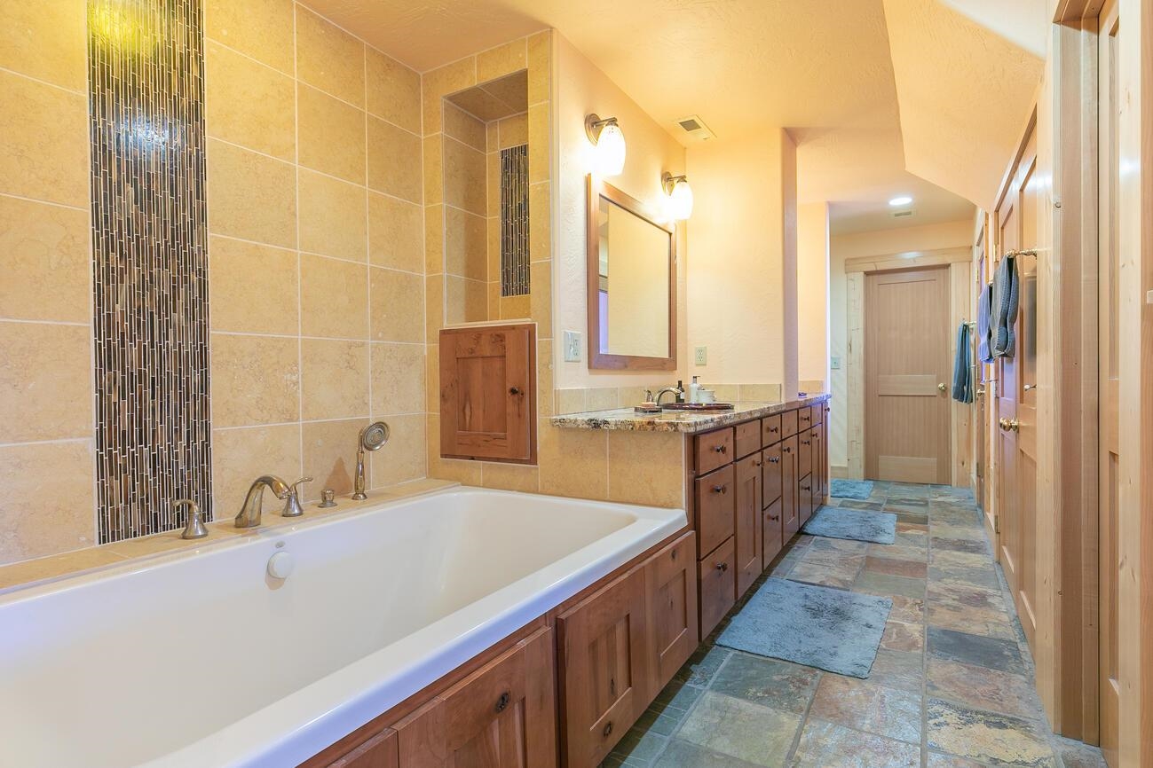 1711 Smith Lake Road Graeagle, CA 96103 - Photo 12 of 26 a bathroom with a tub sink shower and a mirror