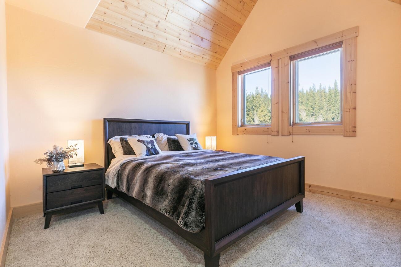 1711 Smith Lake Road Graeagle, CA 96103 - Photo 14 of 26 a bed sitting in a bedroom next to a window