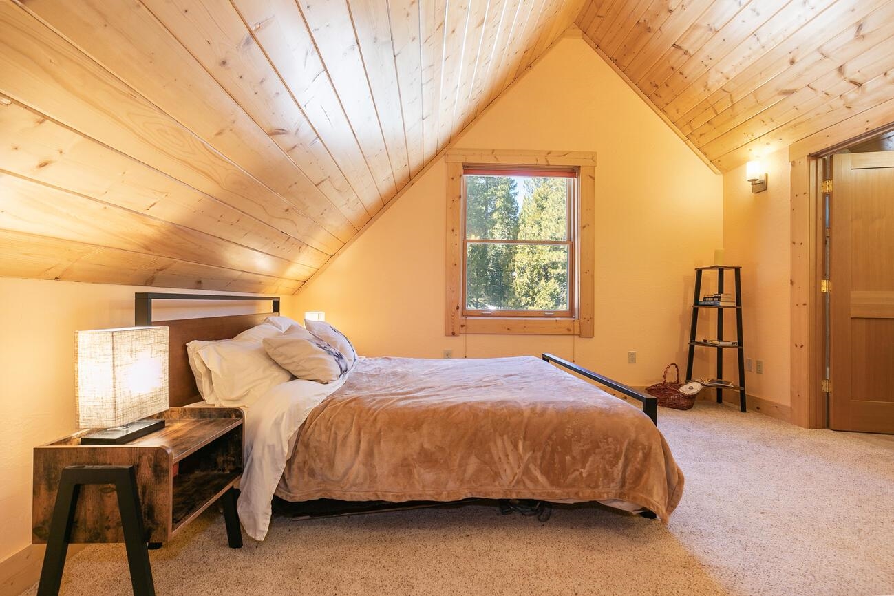 1711 Smith Lake Road Graeagle, CA 96103 - Photo 16 of 26 a bedroom with a bed and a window