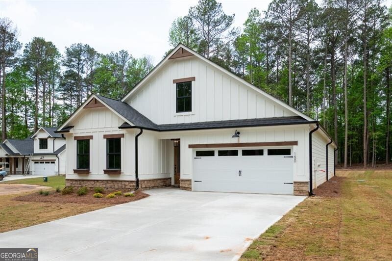 150 Doris Path Dallas, GA 30157 - Photo 1 of 36 a view of a wooden house with a yard and large trees