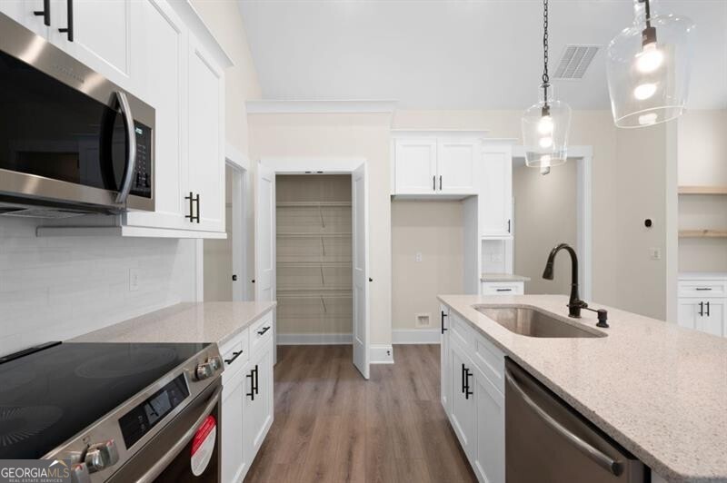150 Doris Path Dallas, GA 30157 - Photo 17 of 36 a kitchen with a sink and a stove top oven