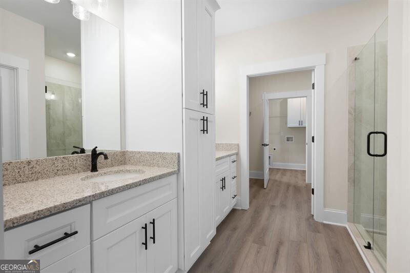 150 Doris Path Dallas, GA 30157 - Photo 20 of 36 a en suite bathroom with a granite countertop sink mirror and shower
