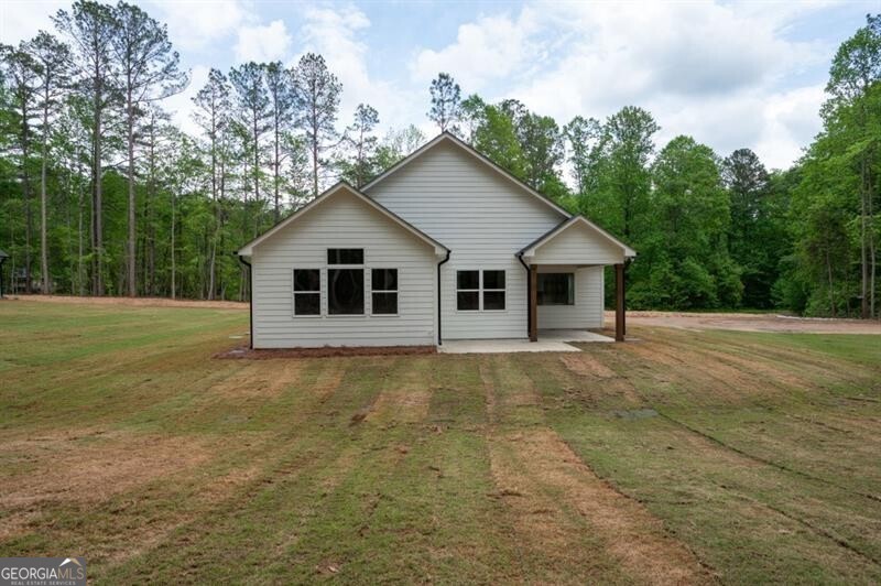 150 Doris Path Dallas, GA 30157 - Photo 34 of 36 a view of a house with backyard and trees