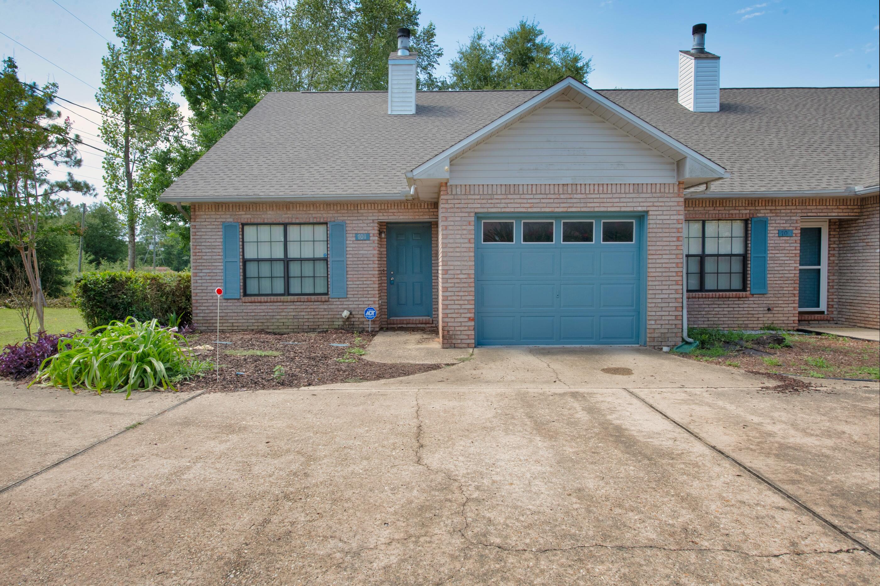 701 Valley Road, Unit 1 Crestview, FL 32539 - Photo 1 of 20 a front view of a house with a yard and garage