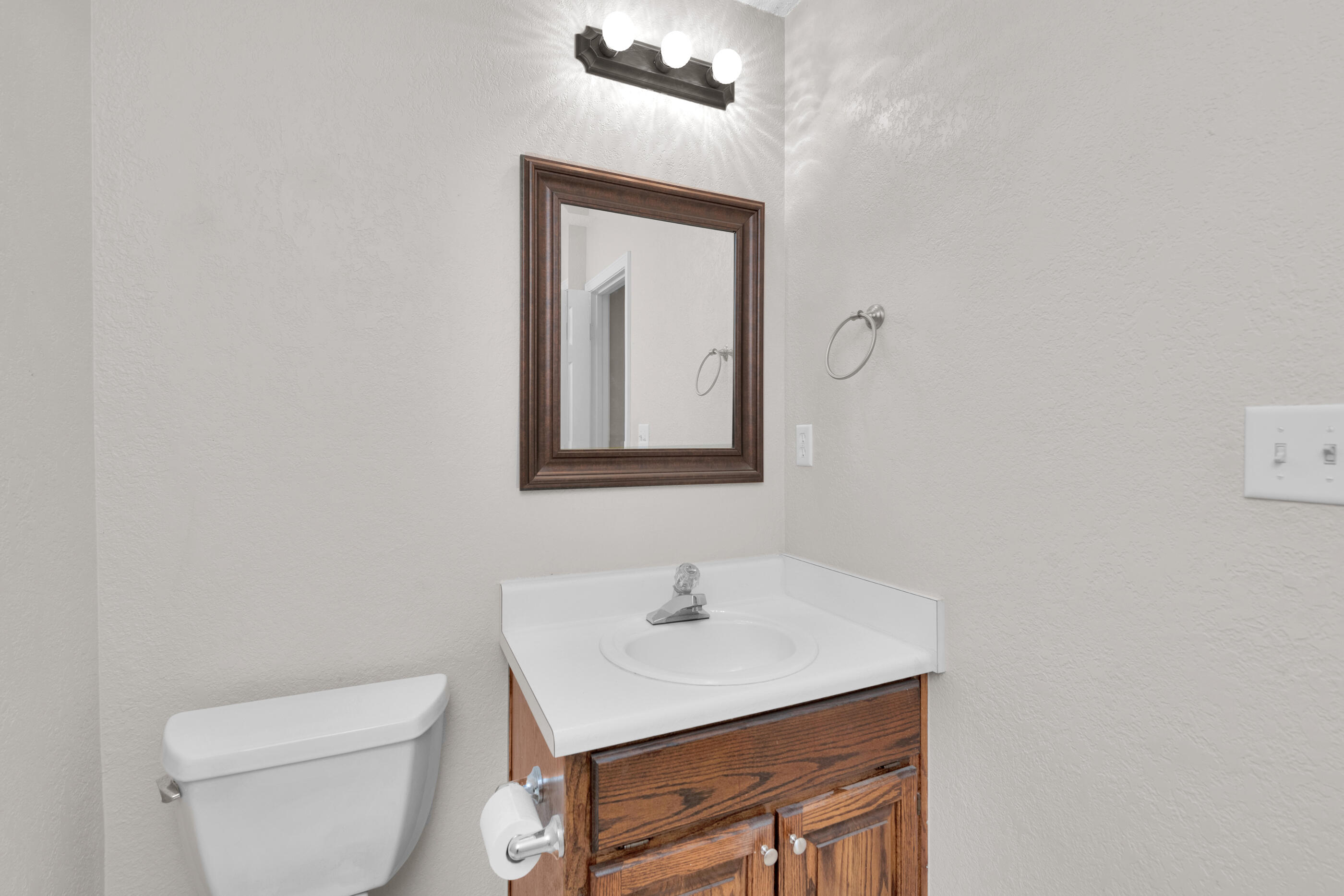 701 Valley Road, Unit 1 Crestview, FL 32539 - Photo 12 of 20 a bathroom with a toilet a sink and mirror
