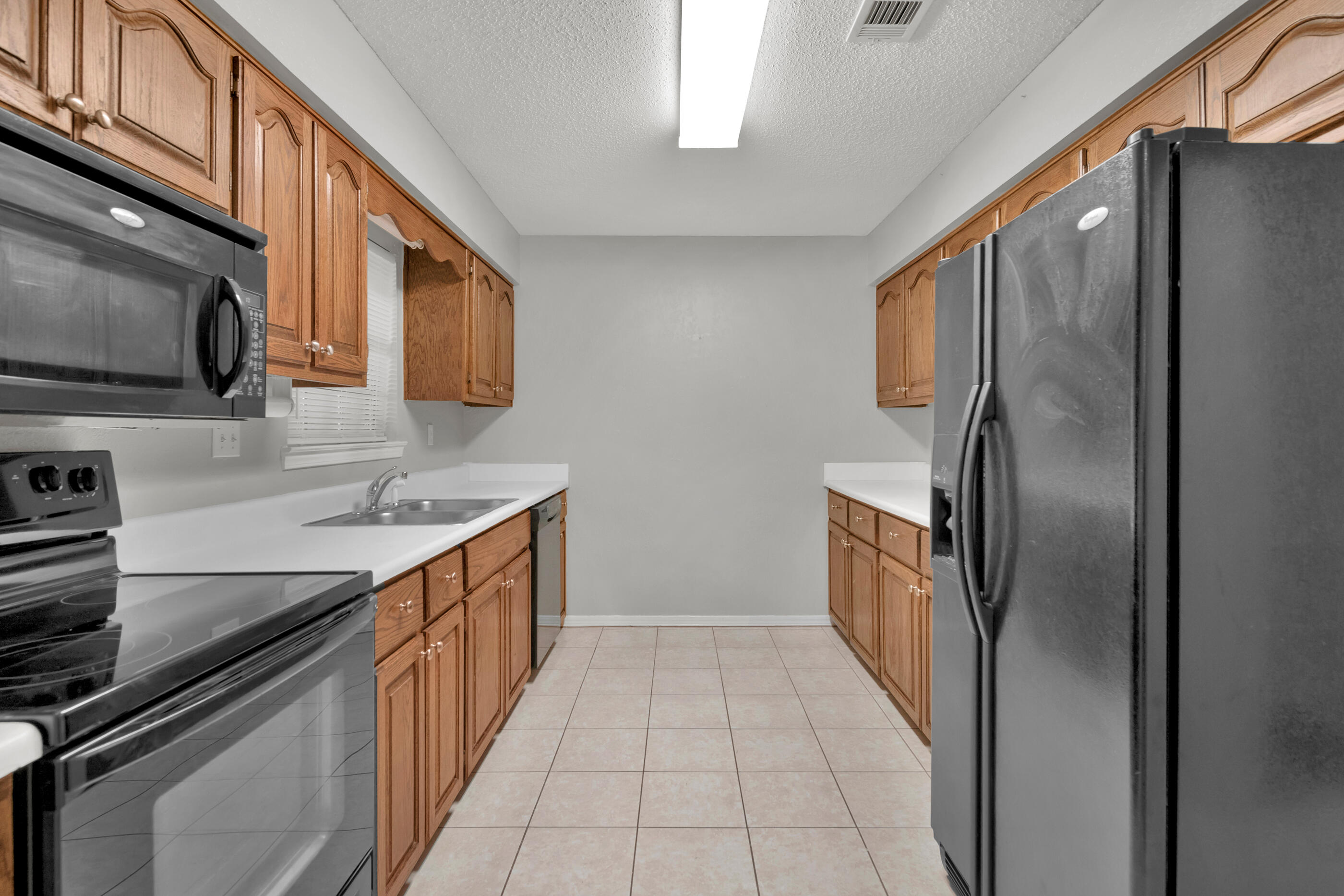 701 Valley Road, Unit 1 Crestview, FL 32539 - Photo 9 of 20 a kitchen with stainless steel appliances granite countertop a refrigerator and a stove top oven