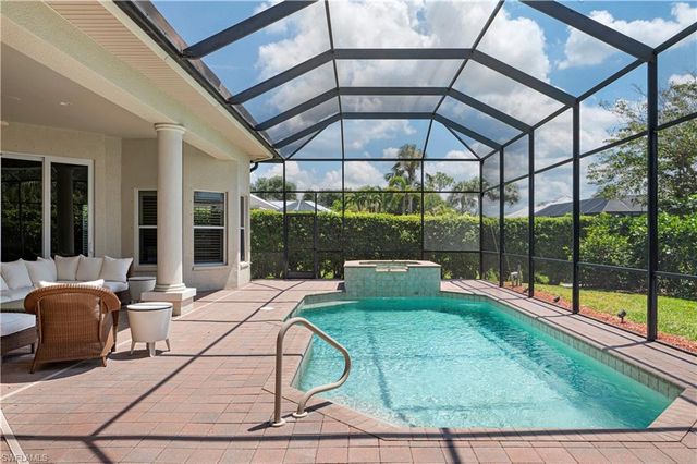 a patio with yard glass top table and chairs