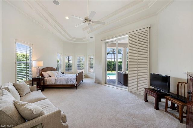 a bedroom with furniture and a flat screen tv