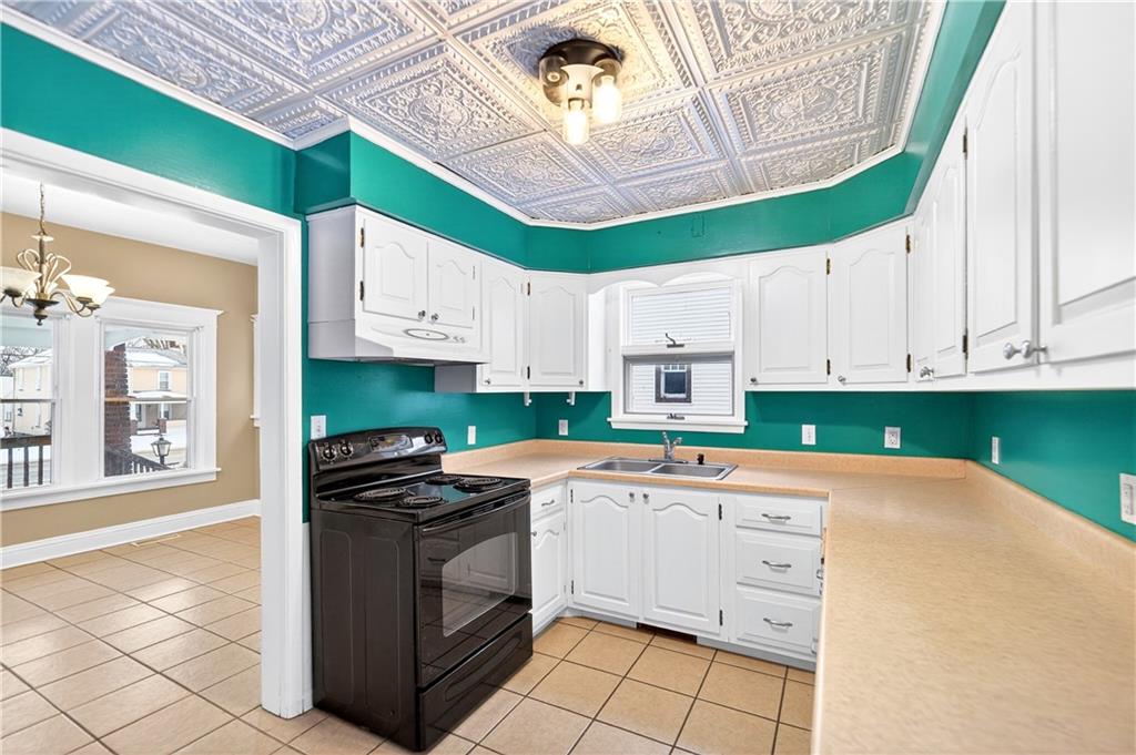 66 Conneaut Lake Road Greenville, PA 16125 - Photo 13 of 30 a kitchen with a stove a sink and a refrigerator