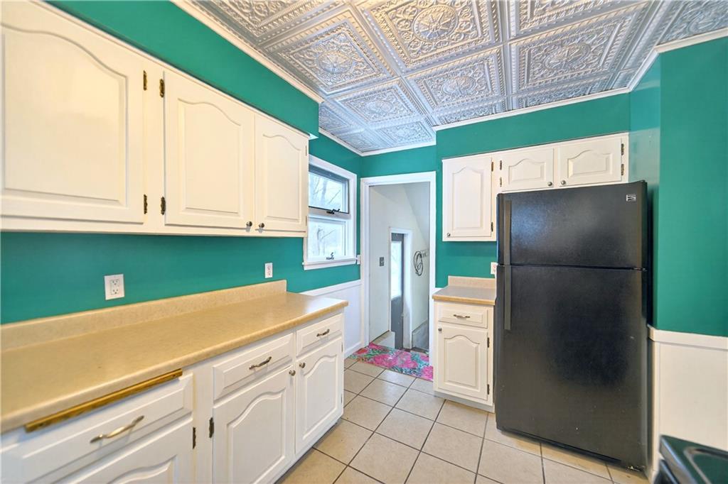 66 Conneaut Lake Road Greenville, PA 16125 - Photo 14 of 30 a kitchen with kitchen island a refrigerator sink and cabinets