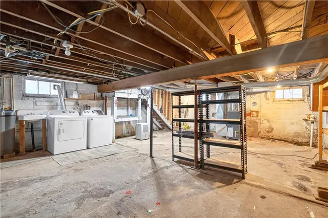 a view of a white house with large windows and couches chairs