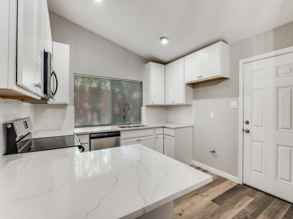 4523 Hamblen Drive Dallas, TX 75232 - Photo 11 of 25 a kitchen with stainless steel appliances granite countertop a stove a sink and a microwave