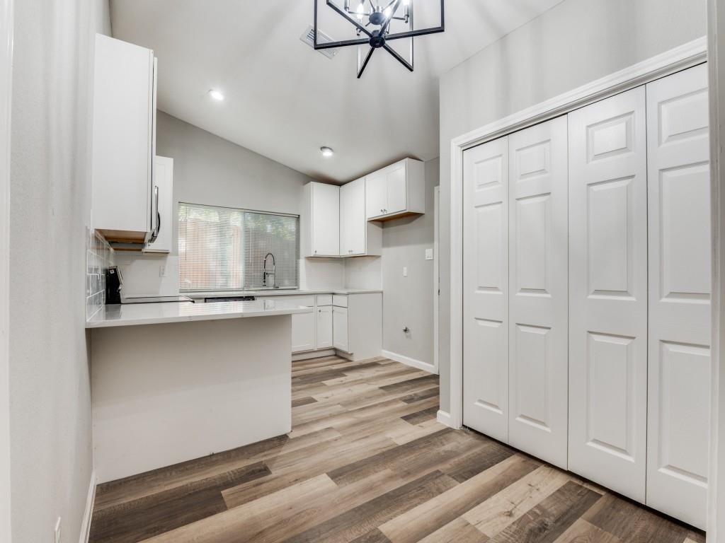 4523 Hamblen Drive Dallas, TX 75232 - Photo 12 of 25 a kitchen with kitchen island white cabinets and stainless steel appliances
