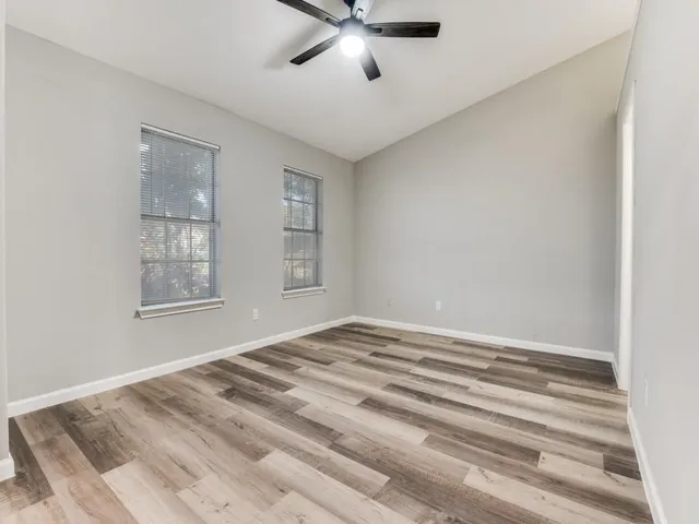 a view of a livingroom with a ceiling fan and window