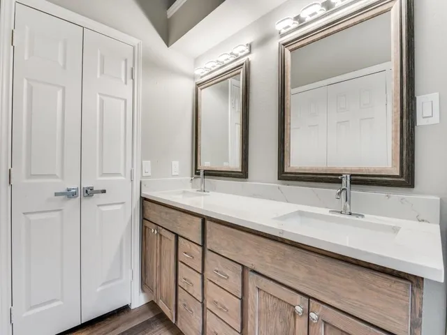 a bathroom with a double vanity sink and a mirror