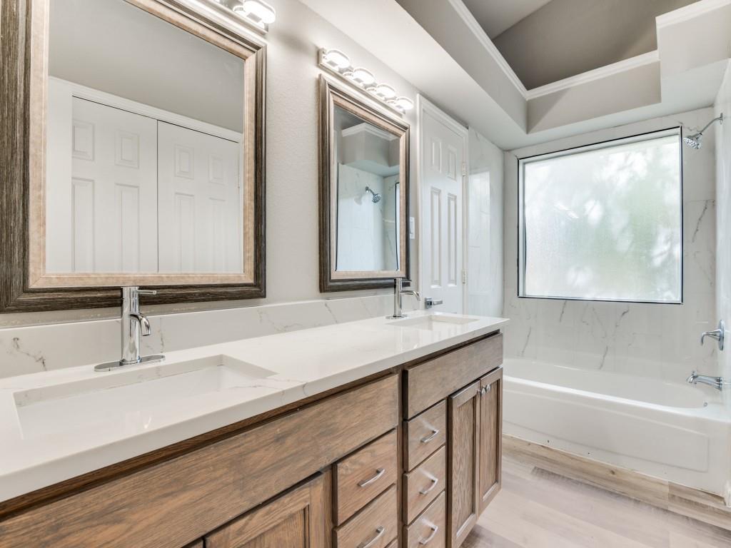 4523 Hamblen Drive Dallas, TX 75232 - Photo 21 of 25 a bathroom with a sink and a mirror