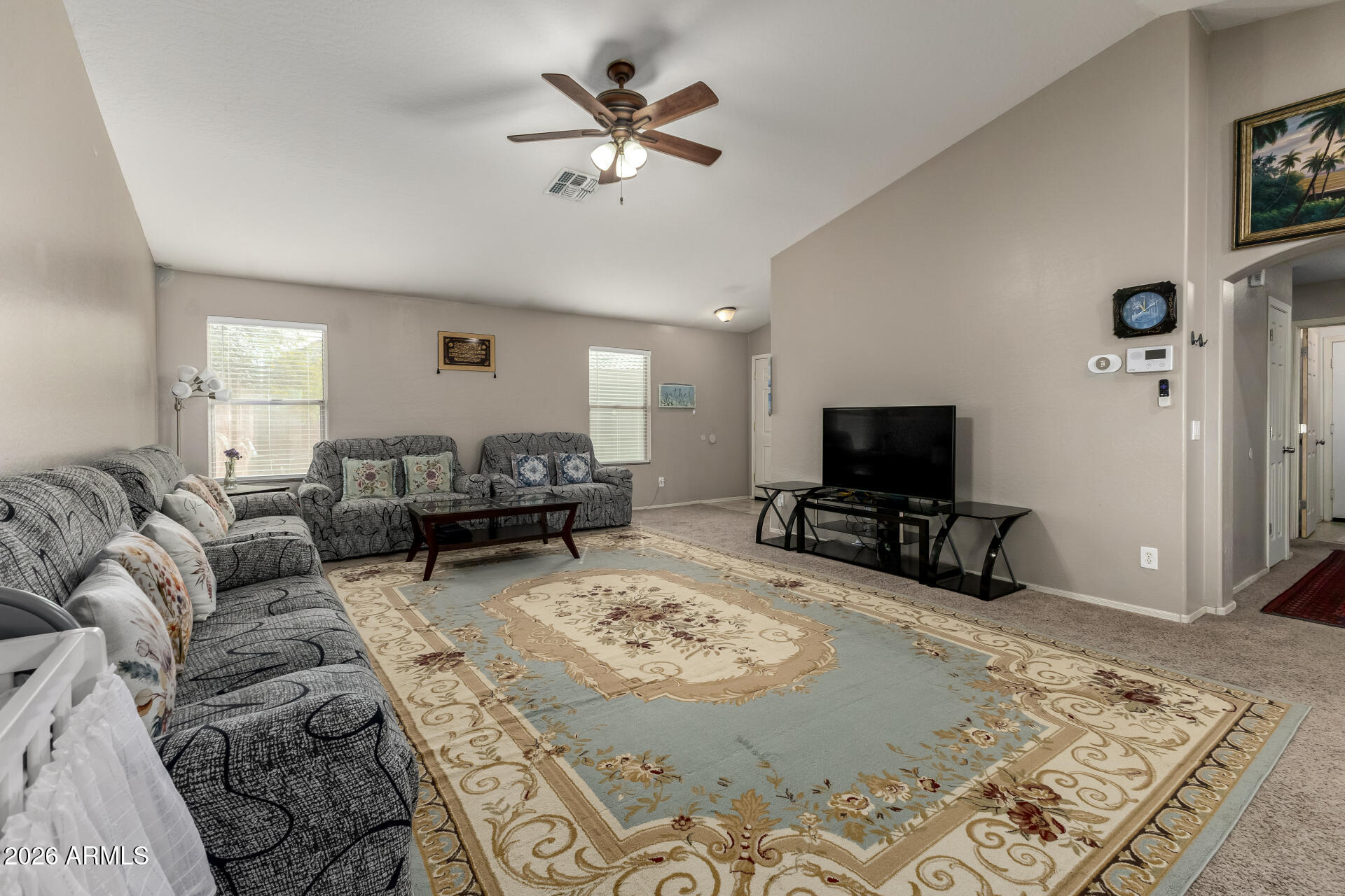 10762 West Joblanca Road Avondale, AZ 85323 - Photo 8 of 36 a living room with furniture a flat screen tv and a fireplace