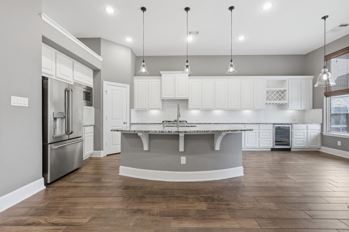 27971 Arden Trail Spring, TX 77386 - Photo 10 of 50 Magazine worthy island kitchen with bar seating, custom lighting and the fridge stays.