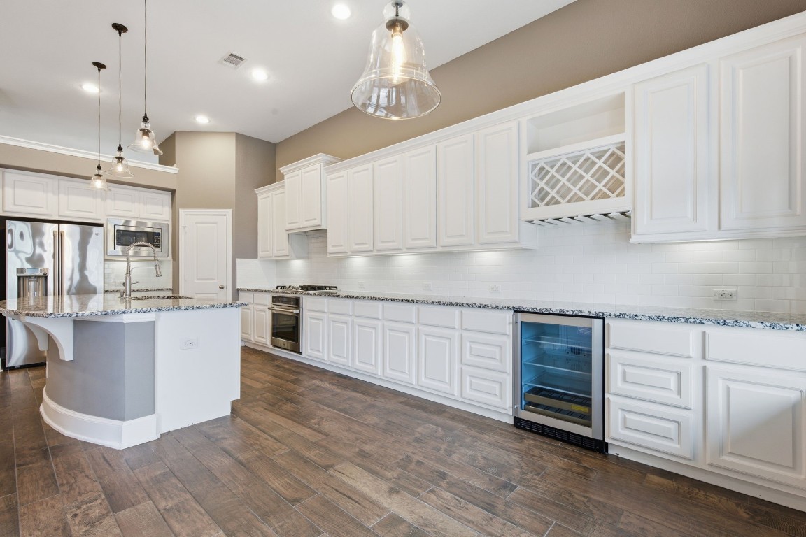 27971 Arden Trail Spring, TX 77386 - Photo 13 of 50 This upgraded extension in the kitchen adds tons of counter space, storage, a wine fridge, wine storage and makes a wonderful serving area for entertaining.