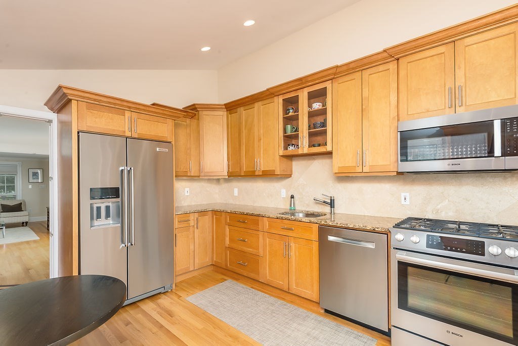 1844 Main Street, Unit 1844 Concord, MA 01742 - Photo 12 of 42 a kitchen with stainless steel appliances granite countertop a refrigerator and a stove top oven
