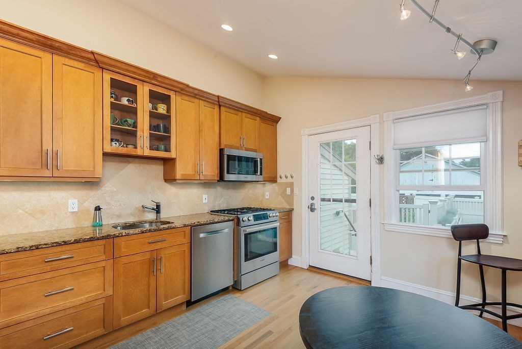 1844 Main Street, Unit 1844 Concord, MA 01742 - Photo 15 of 42 a kitchen with stainless steel appliances granite countertop a stove and a sink