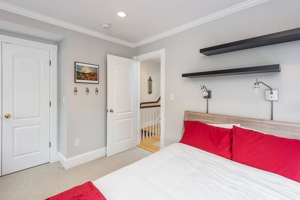 1844 Main Street, Unit 1844 Concord, MA 01742 - Photo 18 of 42 a bedroom with a large bed and a dresser