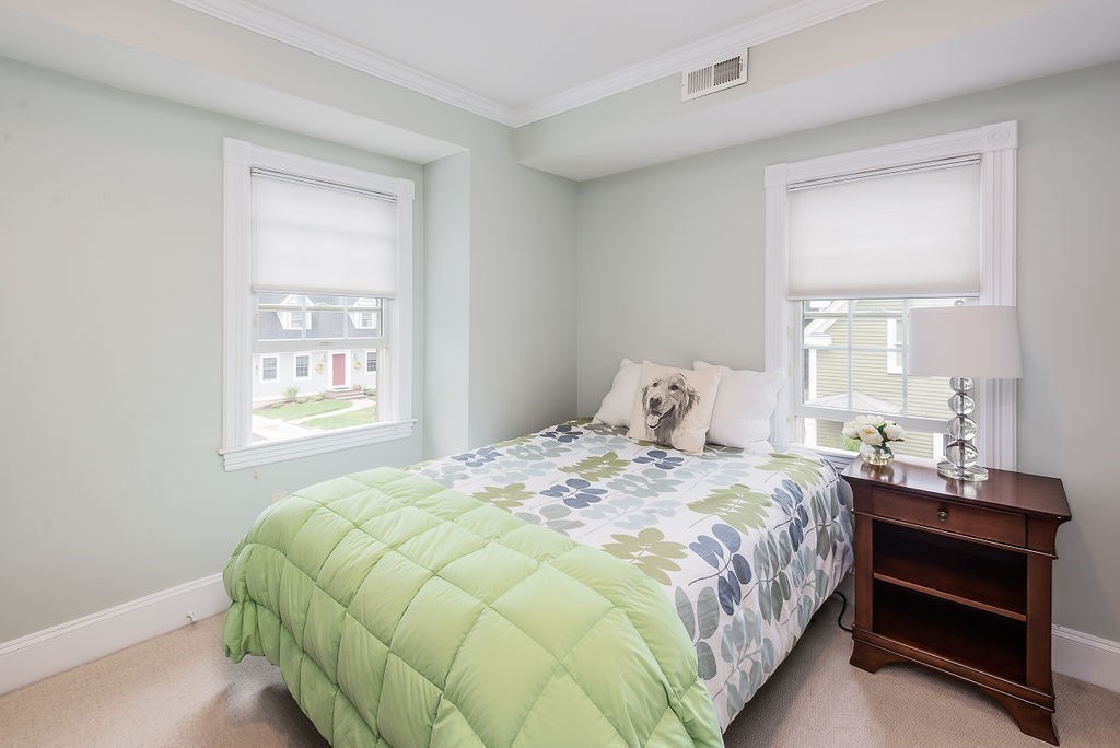 1844 Main Street, Unit 1844 Concord, MA 01742 - Photo 19 of 42 a bedroom with a bed and window