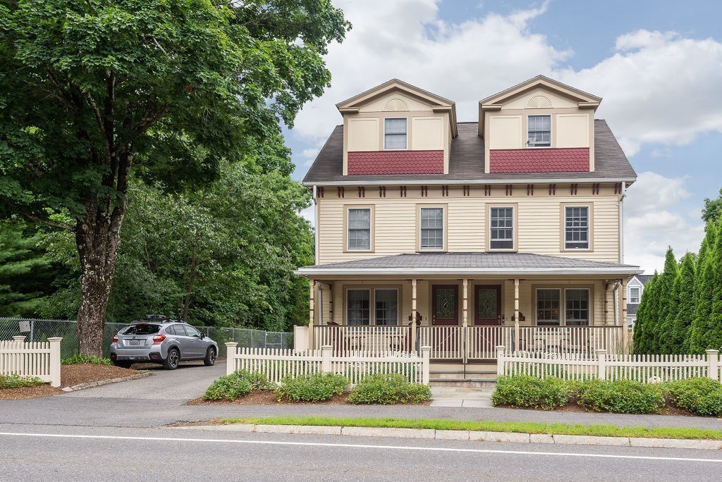 1844 Main Street, Unit 1844 Concord, MA 01742 - Photo 2 of 42 a front view of a house with a yard