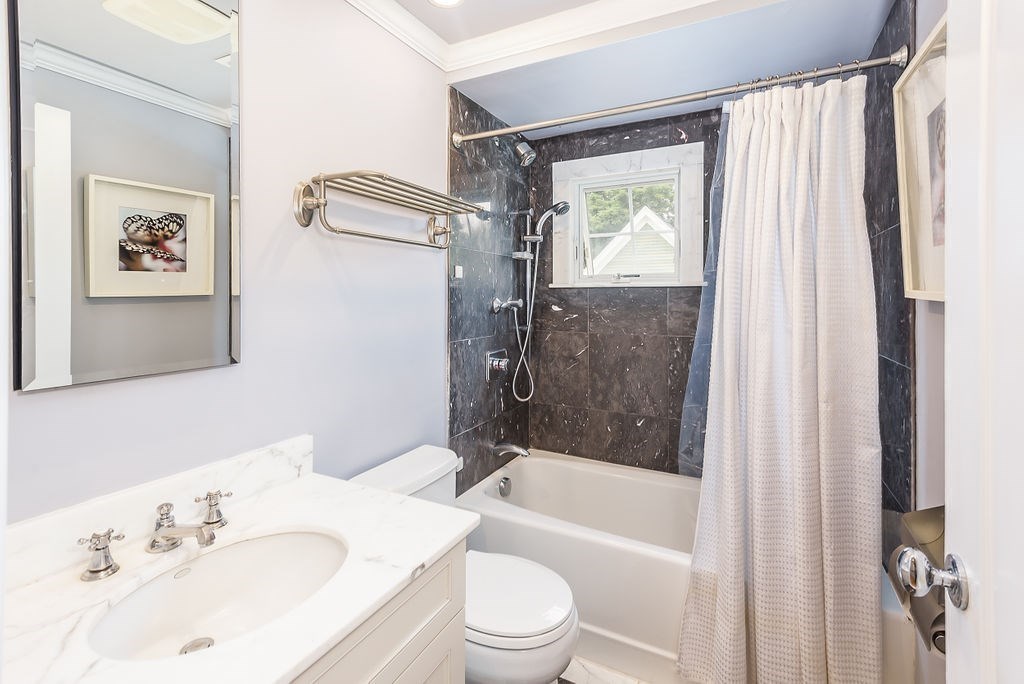 1844 Main Street, Unit 1844 Concord, MA 01742 - Photo 21 of 42 a bathroom with a bathtub shower sink vanity and toilet