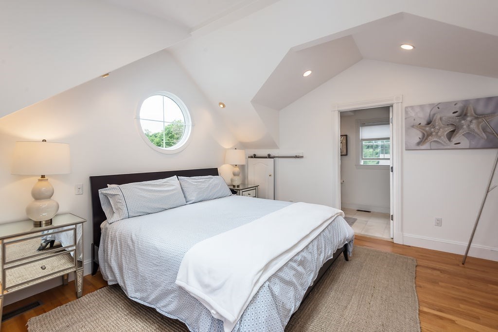 1844 Main Street, Unit 1844 Concord, MA 01742 - Photo 24 of 42 a large bed sitting in a bedroom and table